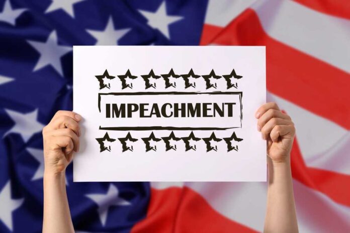 shutterstock_2067948272.jpg featured image Hands holding impeachment sign over American flag.
