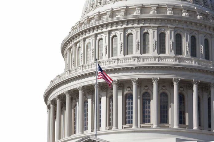 shutterstock_2082475843.jpg featured image U.S. Capitol dome with American flag flying.
