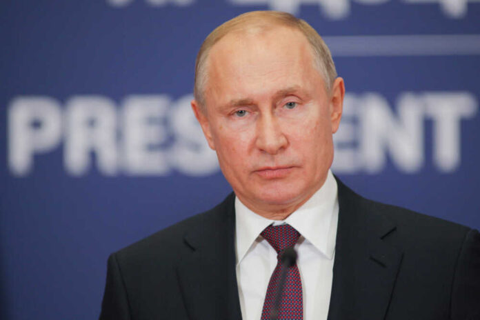 shutterstock_1287905686.jpg featured image Vladimir Putin in suit and tie speaking at a podium