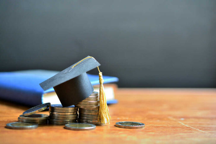 shutterstock_1427912792.jpg featured image Graduation cap on top of coins to represent student loans