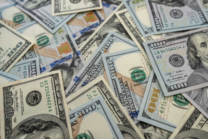 shutterstock_1912026715.jpg featured image Scattered hundred dollar bills with Benjamin Franklin's portrait.