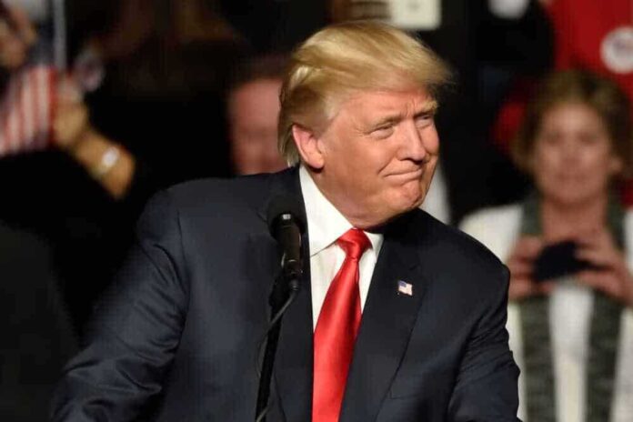 shutterstock_546595348-1.jpg featured image Donald Trump, Blurry background, black suit.