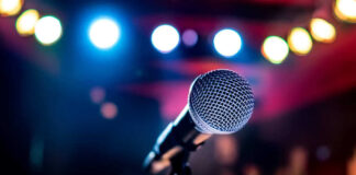 Microphone with colorful stage lights in the background.