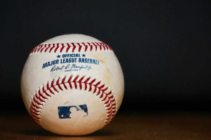 shutterstock_1403432705.jpg featured image Major League Baseball ball with commissioner signature and logo.