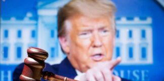 Gavel with Donald Trump speaking in the background.
