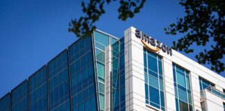 Modern office building with Amazon logo against sky