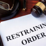 Gavel glasses pen restraining order document on table
