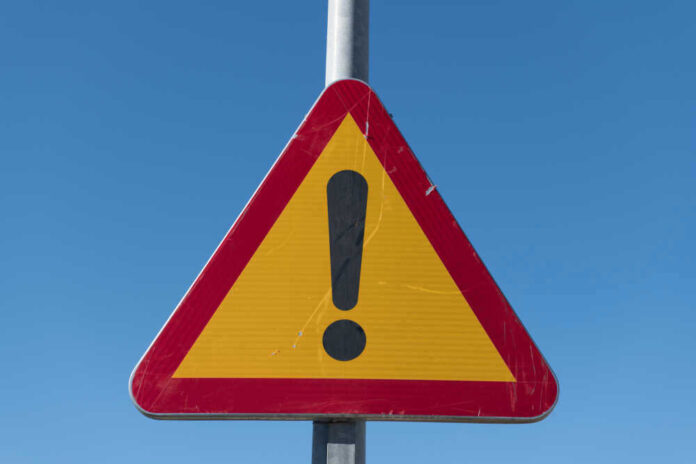 shutterstock_1306935058.jpg Triangular warning sign with exclamation mark