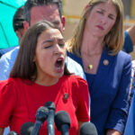 Alexandria Ocasio-Cortez speaking passionately at microphones.