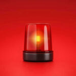 Red emergency light on solid red background