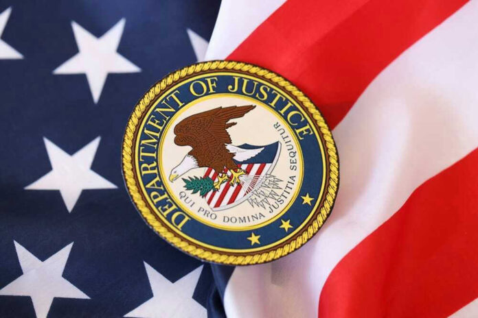 shutterstock_2439221439.jpg Department of Justice seal on American flag
