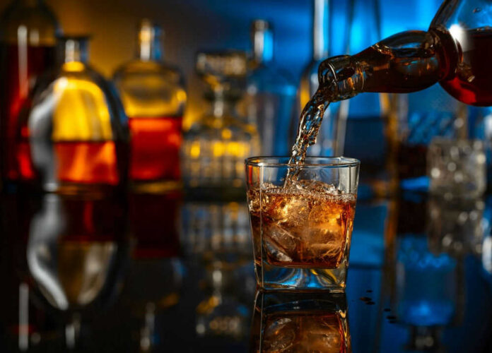 shutterstock_2459806379.jpg Pouring Whiskey