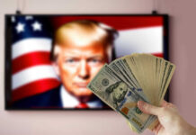 Hand holding cash in front of American flag background with Donald Trump's face