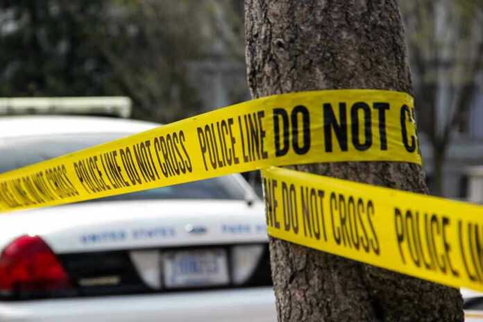 789649249 Police tape surrounding a tree and police car