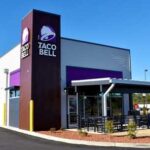Taco Bell’s Shocking Y2K Comeback: All Under $3 Exterior view of a Taco Bell restaurant with outdoor seating area