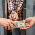 Feds Crack Human Smuggling Ring (Video) Hands exchanging money in front of chained person