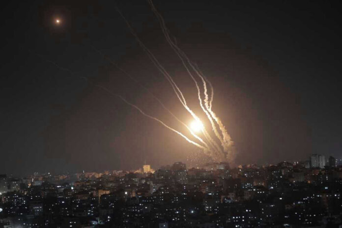 Night sky with rockets launching over a city