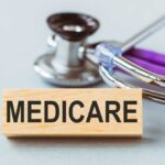 Medicare’s AI Expansion Sparks Fear and Fury Wooden block with MEDICARE text next to a stethoscope