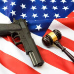 Supreme Court Takes on Gun Ban Gun and gavel on a US flag