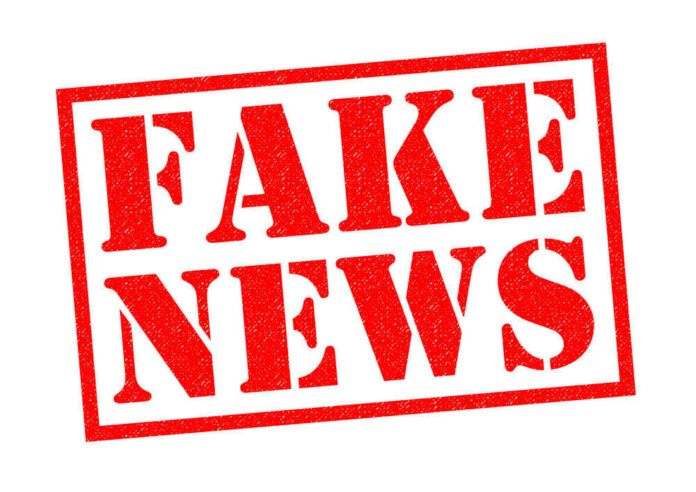 Fake news red stamp with textured appearance