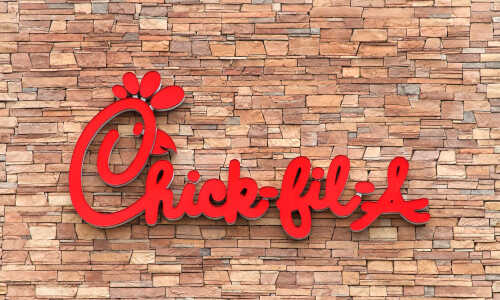 Chick-fil-A restaurant sign on a stone wall