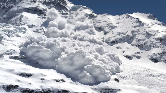An avalanche cascading down a snowy mountain slope