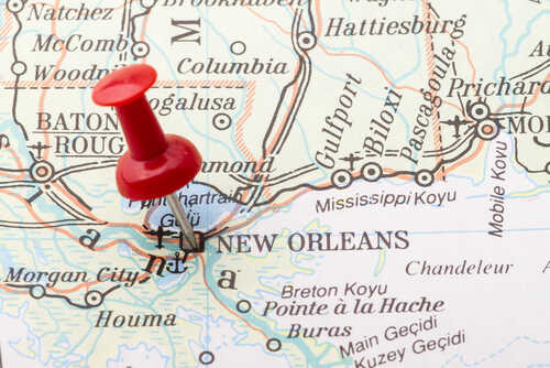 A red pushpin marking New Orleans on a map