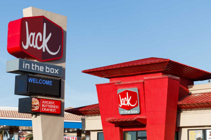 Exterior view of a Jack in the Box restaurant with a welcome sign