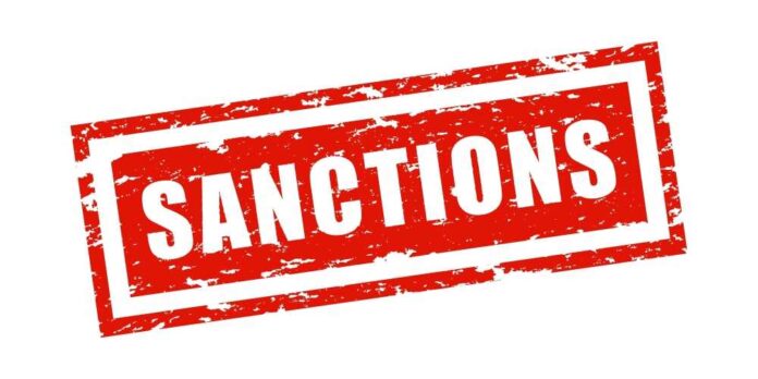Red stamp with the word 'SANCTIONS' in bold white letters