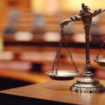 ‘Prisoner of War’ Claim Stuns Court Scales of justice in an empty courtroom.
