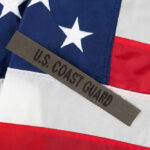 U.S. Coast Guard patch on American flag.