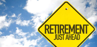 A yellow road sign indicating retirement is just ahead