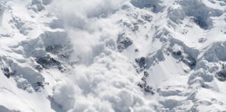 An avalanche cascading down a snowy mountain