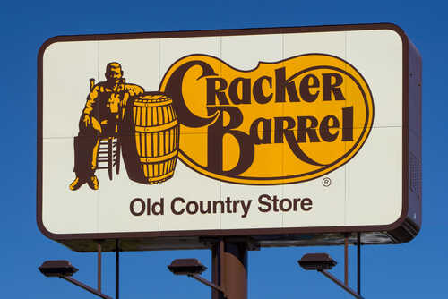 Cracker Barrel Old Country Store sign featuring a man sitting next to a barrel