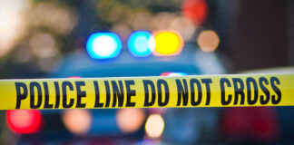 Police tape and lights at crime scene.