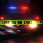24-Year-Old SLAUGHTERS Entire Family Police car with flashing lights behind caution tape.