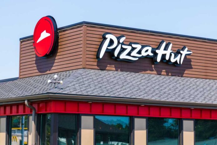 Exterior view of a Pizza Hut restaurant with a prominent logo