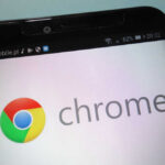 Close-up of a smartphone displaying the Chrome logo and interface