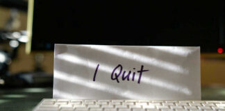 Envelope reading I Quit behind keyboard.