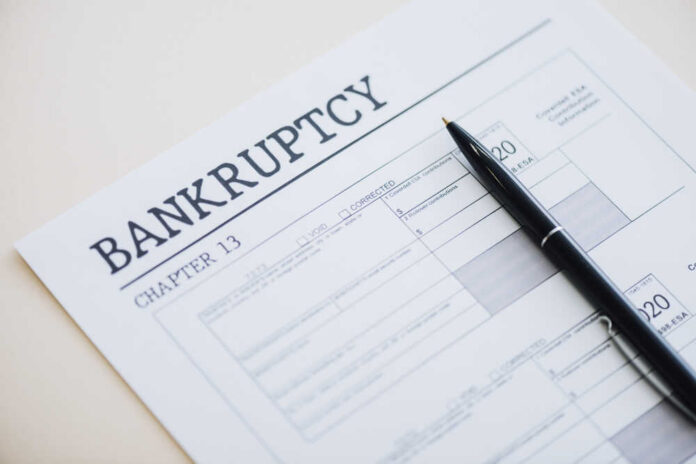 Bankruptcy Chapter 13 form with a pen resting on it