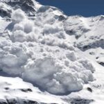 An avalanche cascading down a snowy mountain slope