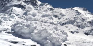An avalanche cascading down a snowy mountain slope