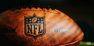 Close-up of an NFL football on grass.