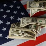 Trump Budget Sparks Revolt Dollar bills arranged on an American flag