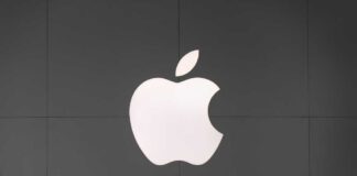 Apple logo displayed on a dark wall