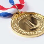 Gold medal with a red, white, and blue ribbon