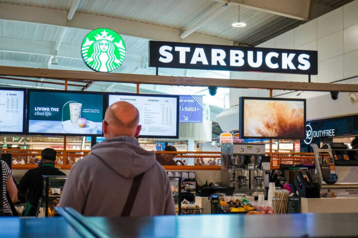 Starbucks counter in busy airport shopping area