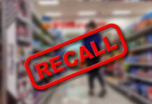 Recall stamp on blurred store aisle background.