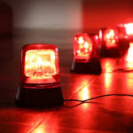 IMMINENT Dam Failure Sparks Urgent Evacuations Red emergency lights on dark floor, illuminating the area.
