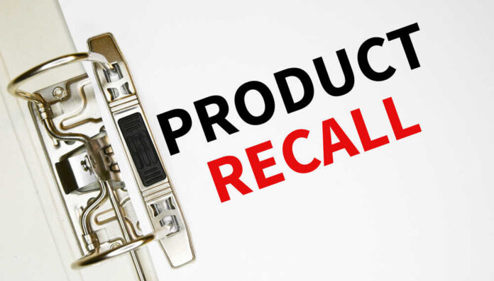 A binder clip holding a sheet of paper with the words 'PRODUCT RECALL' printed in bold letters